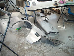 Original front fenders taken down to bare metal revealed no rust or previous damage.