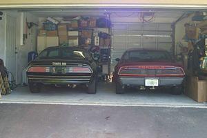 77 Trans Am pre-restoration next to my first car, a 1979 Formula that I have had since 1984.